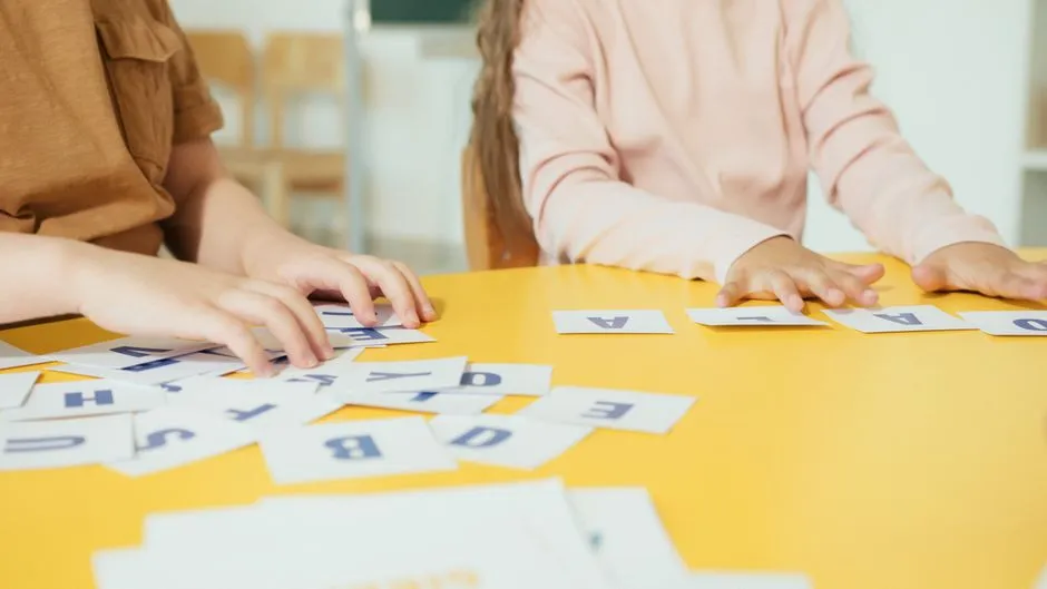 Printed phoneme sort cards cut out and spread across a Year 1 classroom table